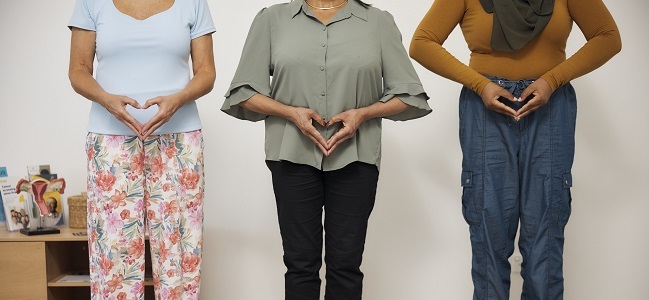 Three people holding their hands in the shape of a heart